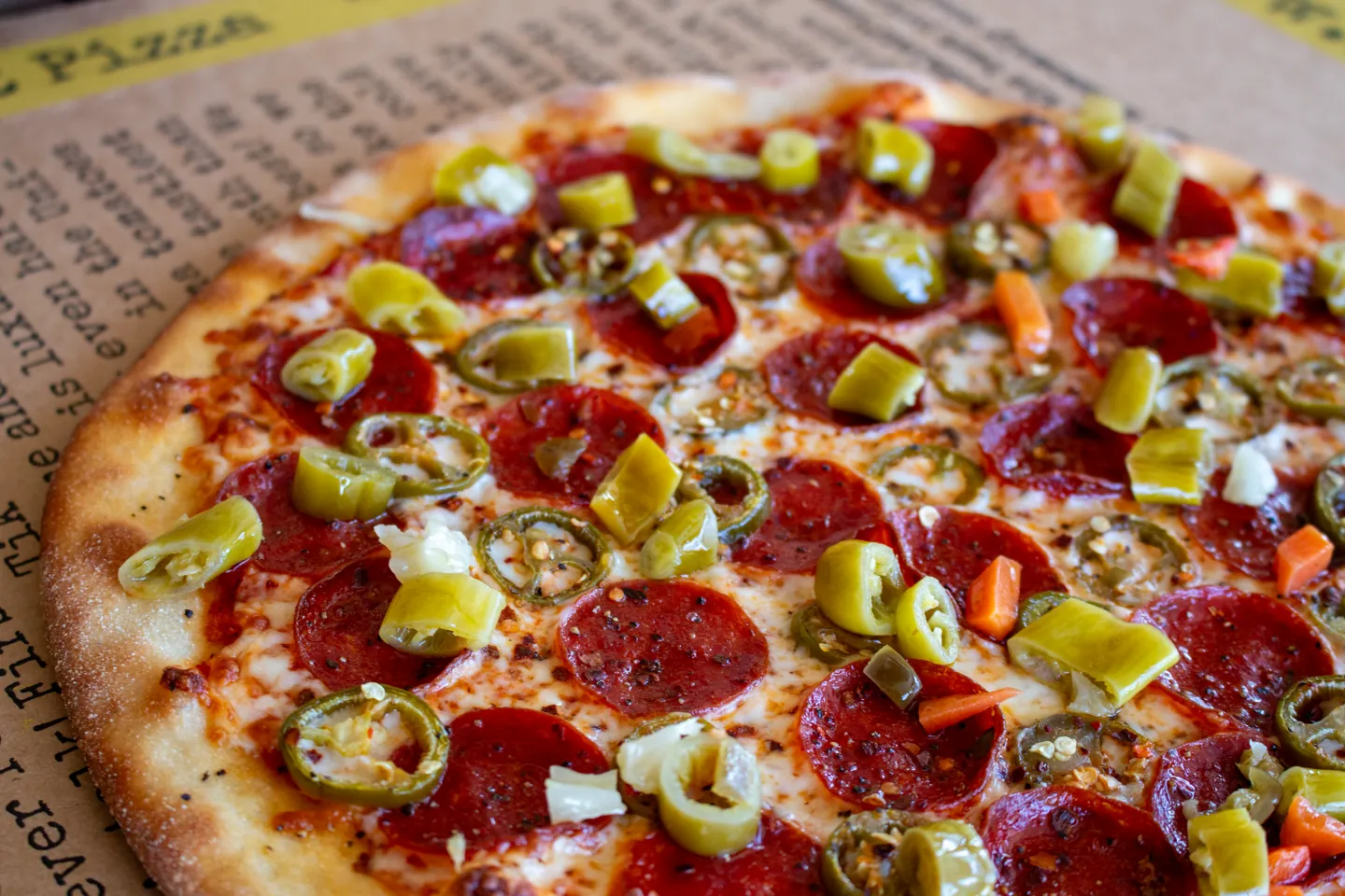 Haughty Pizza topped with all-beef pepperoni, jalapeños, and Zalat peppers